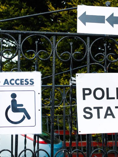A polling station sign and disabled access sign.