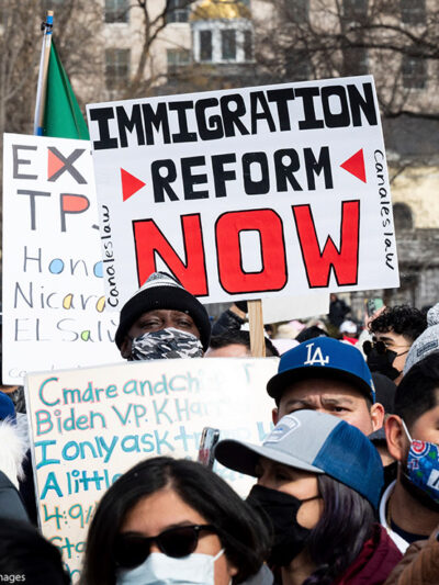 A group of immigration reform demonstrators with a sign that says "Immigration Reform Now."