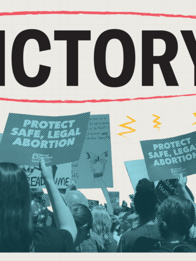 Protestors holding pro reproductive freedom signs under the word Victory!