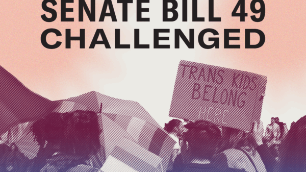 Large group of people protesting government attacks on transgender Missourians. One sign reading "Trans Kids Belong Here"