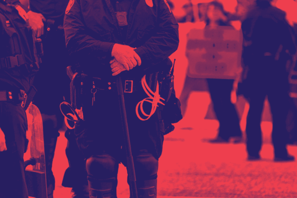 red and dark blue image, police officers standing by with a protester in the background