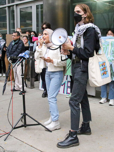 Individuals from Students for Justice in Palestine speak at the Boot Boeing! Free Palestine march and rally while they block all the entrances to Governor Pritzker's Chicago office in downtown Chicago.