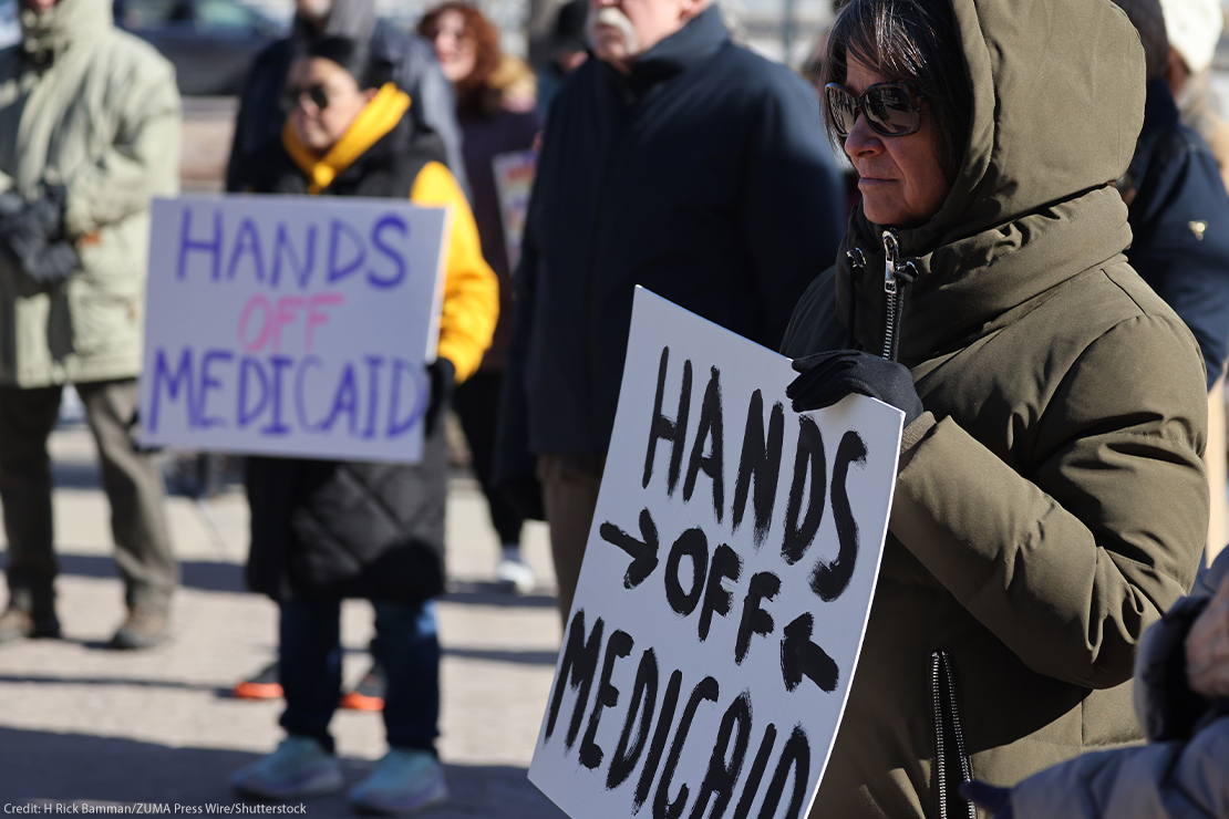 Demonstrators holding signs that read "HANDS OFF MEDICAID" protest the Trump administration's plan to roll back Medicaid expansion during a rally in front of the DuPage County Court House in Illinois.